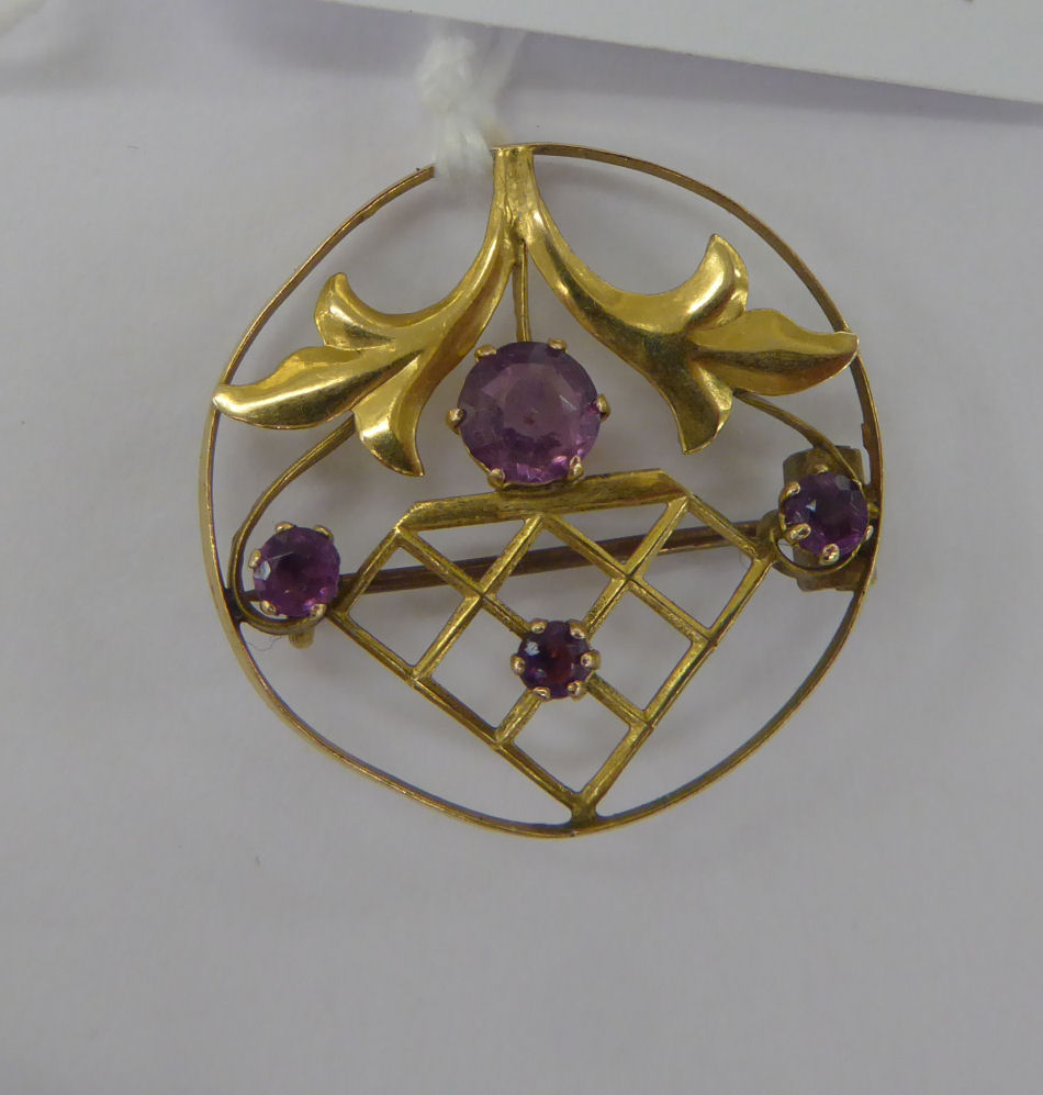 An 'antique' gold coloured metal framed, round brooch,