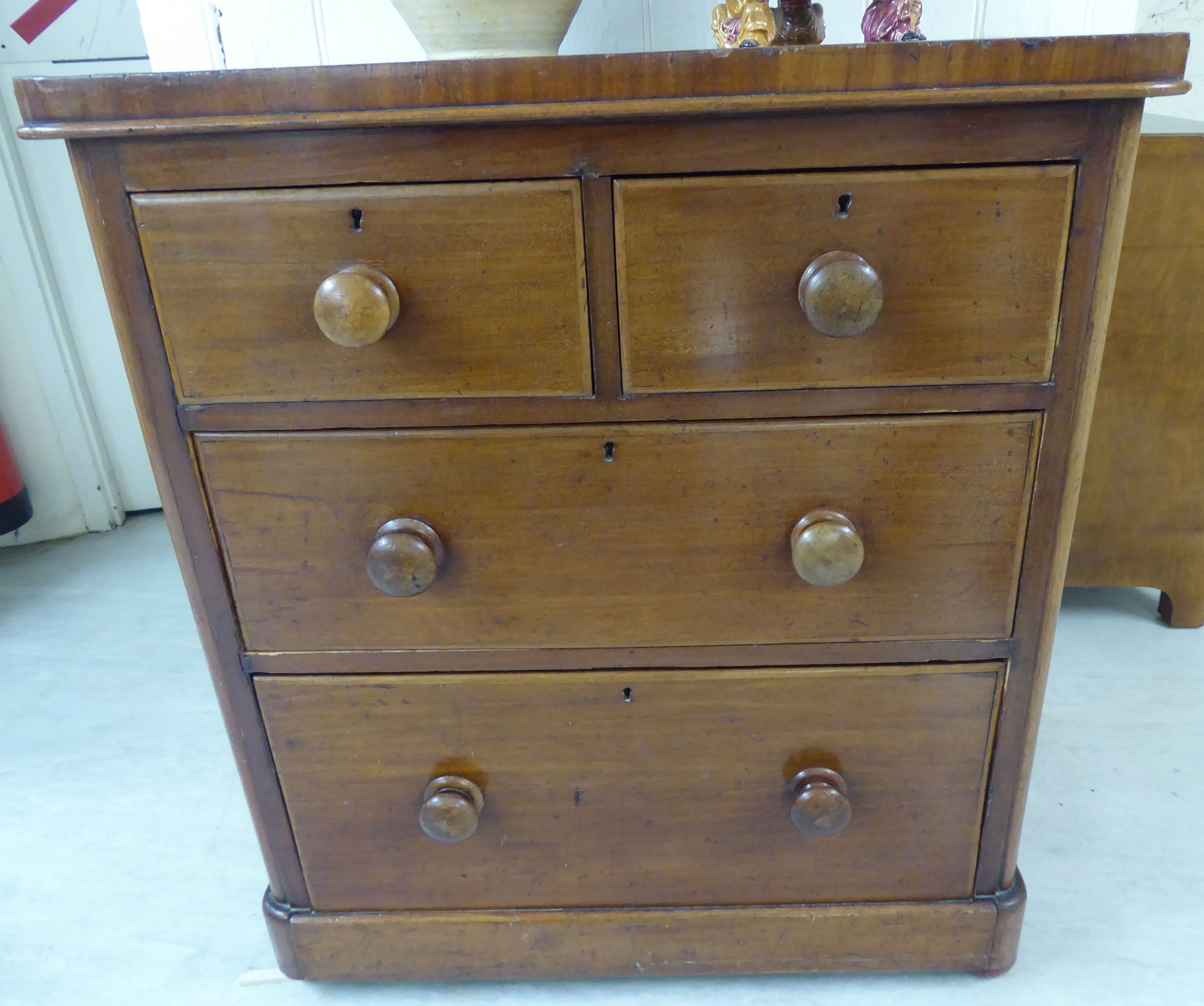 A mid Victorian mahogany four drawer dressing chest with bun handles,