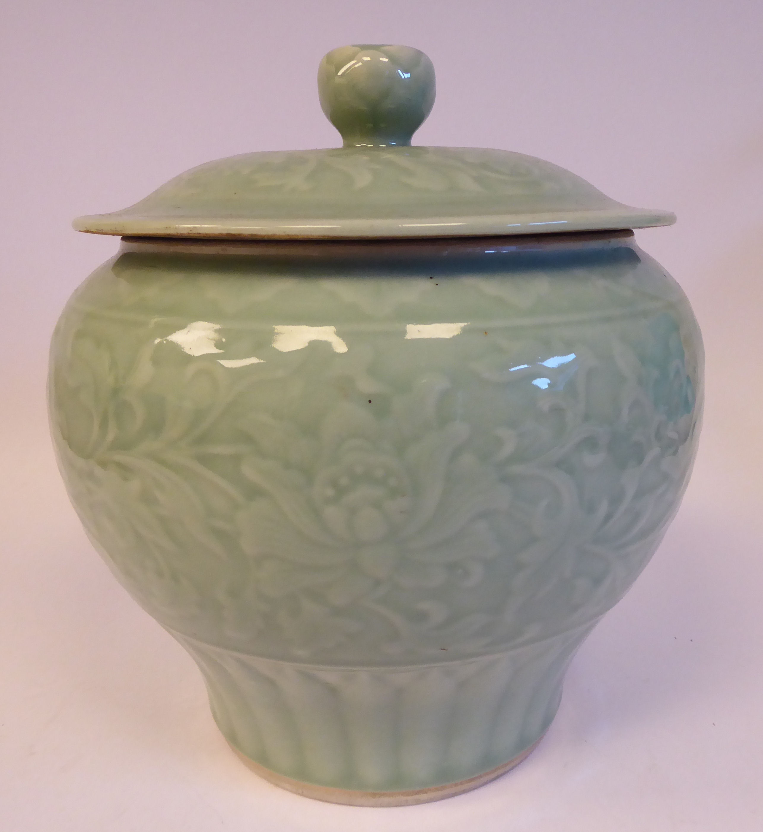 A 20thC Chinese celadon glazed porcelain pot of squat baluster form,