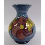 A Moorcroft pottery vase of bulbous form with a waisted neck and flared rim,