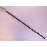 A 1920s malacca walking cane with a turned ivory terminal,