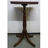 An early 19thC mahogany lectern, the rectangular panelled table top folding on a ratchet,