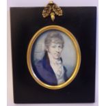 An early 19thC oval portrait miniature, a young man wearing a cravat and blue coat 3'' x 2.