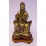A late 19thC Chinese cast bronze figure, a seated elder, holding a book 9.