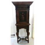 A late 19thC Continental profusely carved oak cabinet on a stand with an overhanging shelf top,