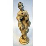 A late 19th/early 20thC Oriental carved ivory figure, a robed man wearing a pillbox design hat,