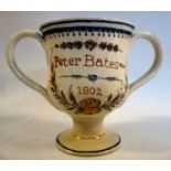 A George III cream glazed earthenware twin handled pedestal 'frog' cup,