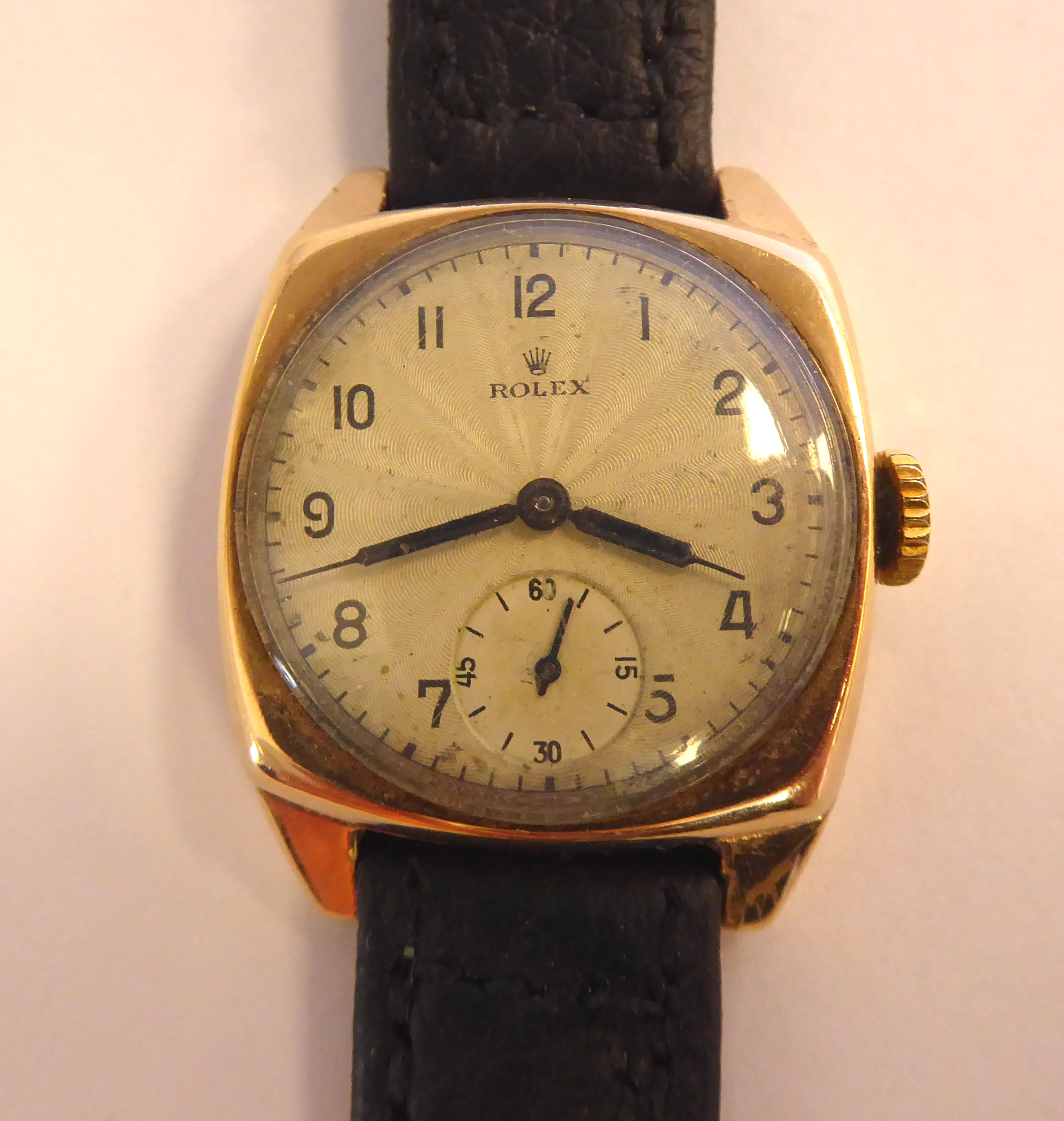 A 1940s Rolex 9ct gold square cased wristwatch, faced by a silvered,