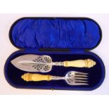 A pair of Edwardian silver fish servers with finely pierced and engraved ornament, on turned,