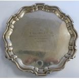 A Georgian style silver salver with a raised piecrust border,