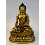 A 20thC Chinese cast gilt bronze figure, Buddha, seated crosslegged,