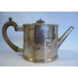 A George III silver drum shaped teapot with a tapered, straight, angled spout,