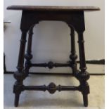 A late 19thC mahogany table stool, the solid top having a lunette carved border,