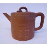 A 19thC Chinese Yixing teapot of drum design with a straight, tapered, angled, spout,