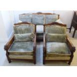 An early/mid 20thC mahogany showwood framed three piece bergere suite with carved crests,