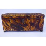 An early 19thC tortoiseshell panelled casket with straight sides and a hinged lid,