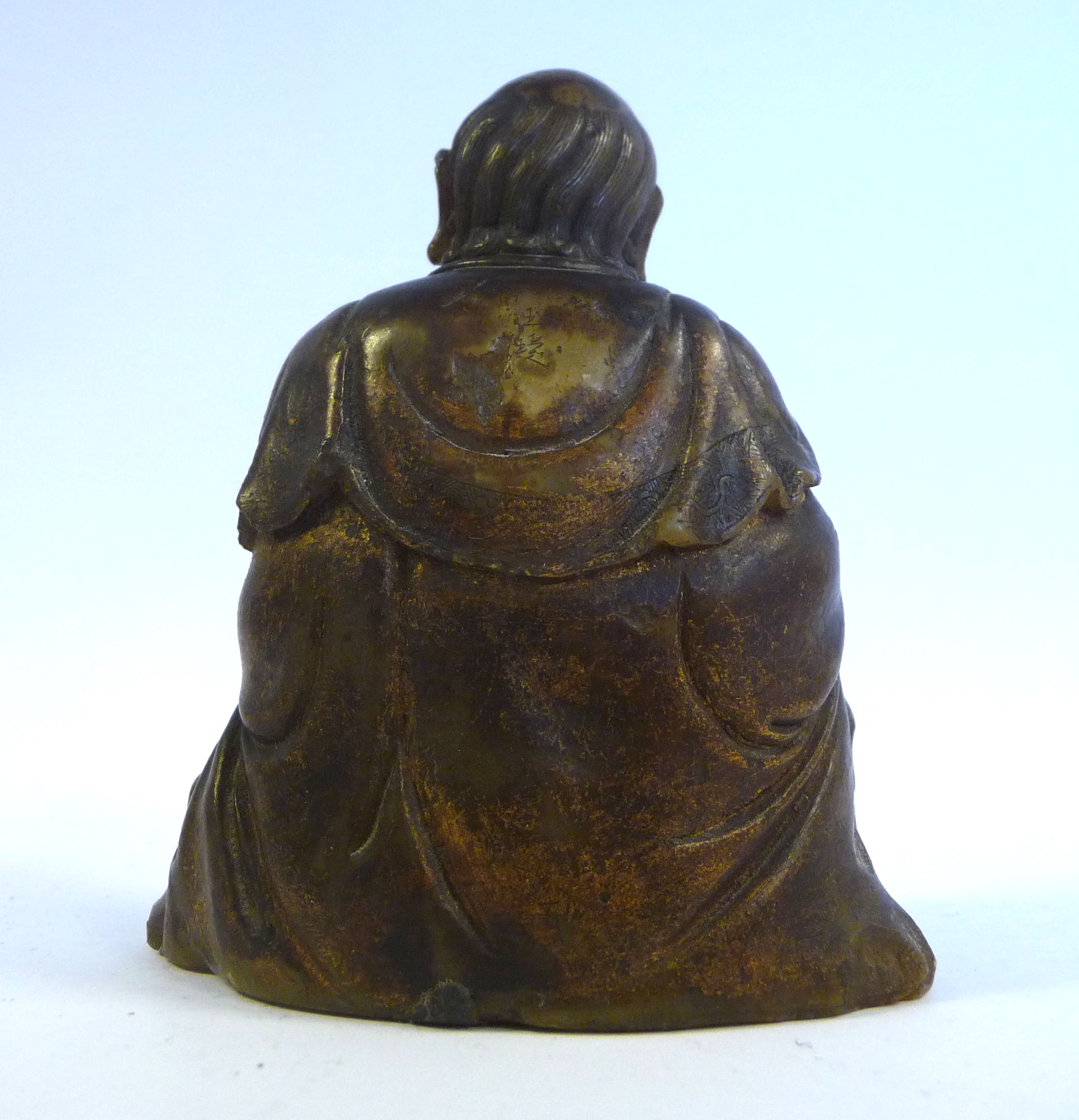 A 19thC Chinese carved brown soapstone seated, robed figure holding a lotus flower, - Image 3 of 6