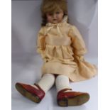 An early 20thC German bisque head doll with painted features and weighted sleeping eyes,
