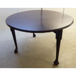 A George III mahogany dining table with deep D-shaped fall flaps, raised on turned, tapered legs,