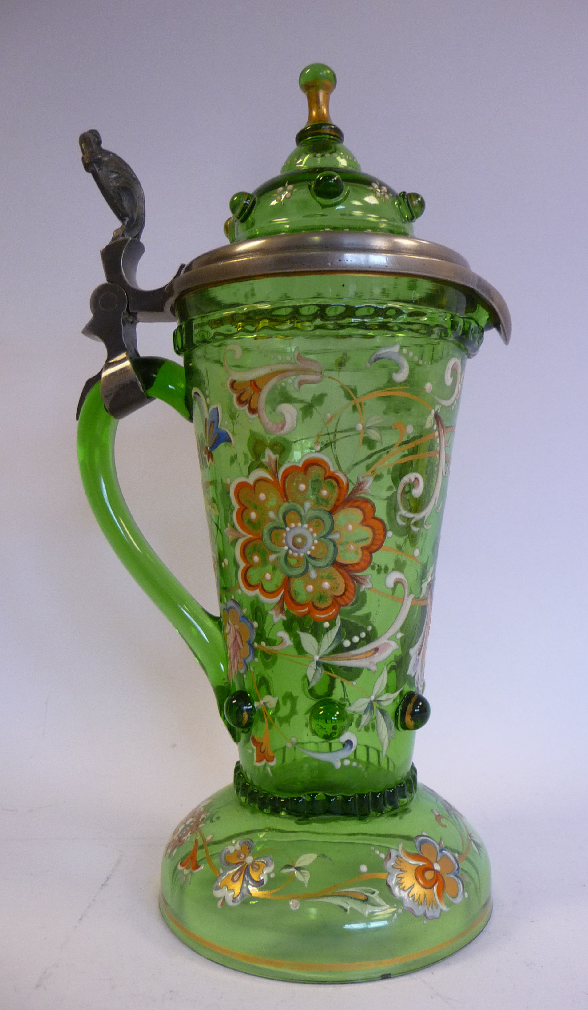 An early 20thC Continental semi-opaque green glass tankard of tapered cylindrical form with a drawn