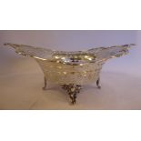 An Edwardian silver cake basket with a round 'bowl', decoratively pierced, flared sides,