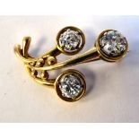 A gold coloured metal organic design brooch, set with three diamonds Total Approx weight 2.