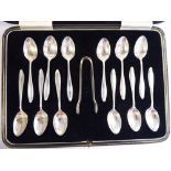 A set of twelve silver teaspoons with waisted stems and a pair of matching sugar tongs CB&S