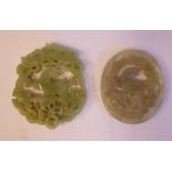 Two similar Chinese carved jade pendants,