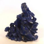 A Chinese carved lapis lazuli seated, robed woman,