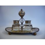 An early 20thC silver plated inkstand, comprising a wire frame set on an oval,