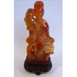 A 19thC Chinese carved mottled pink/iron red agate stone standing robed figure,