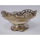 A silver bowl with a dimpled centre and an upstand rim,