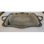 An early 20thC silver plated tray of serpentine outline,