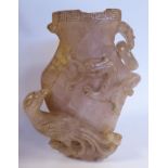 A Chinese carved mottled pink stone vase of flattened baluster form with Greek key style ornament