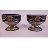 A pair of late 18thC silver salt cellars of oval pedestal form with blue glass liners,