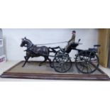 A late 19thC scratch built model of a horsedrawn open carriage in green livery with a driver