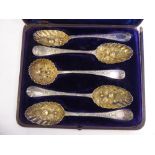 A matched set of four late 18thC identical silver and parcel gilt berry spoons and a sifter spoon