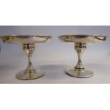 A pair of Edwardian silver sweet dishes with shallow, circular bowls,