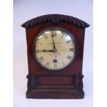 A William IV mahogany cased bracket timepiece with a round arched top, straight sides,