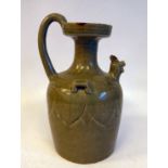 A 19thC Chinese pale green glazed stoneware wine ewer of shouldered form with a short, narrow neck,