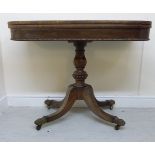 An early 19thC rosewood card table, the rotating foldover top with bead ornament,