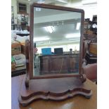 A late Victorian mahogany dressing table mirror, the plate pivotting on scrolled horns,