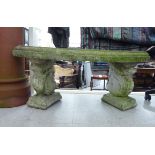 A composition stone terrace bench seat with a curved top,