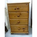 A modern honey coloured pine pedestal chest,