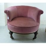 An early 20thC small round backed boudoir chair, upholstered in dusky pink dralon,