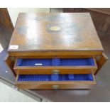 A 1920s stained oak canteen chest with a hinged lid and straight sides,