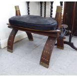 A 20thC saddle stool with a stitched black hide cushion SR
