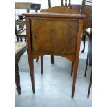 A late 19thC figured walnut night table with a cupboard door, raised on square,