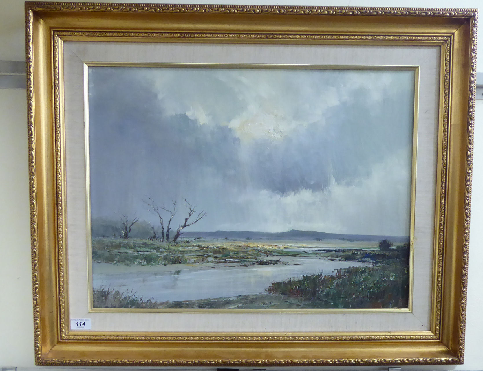 Chris Tugwell - a barren African landscape under a stormy sky oil on board bears a signature