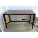 A modern mahogany finished centre table with a mitred top, raised on square, tapered legs,